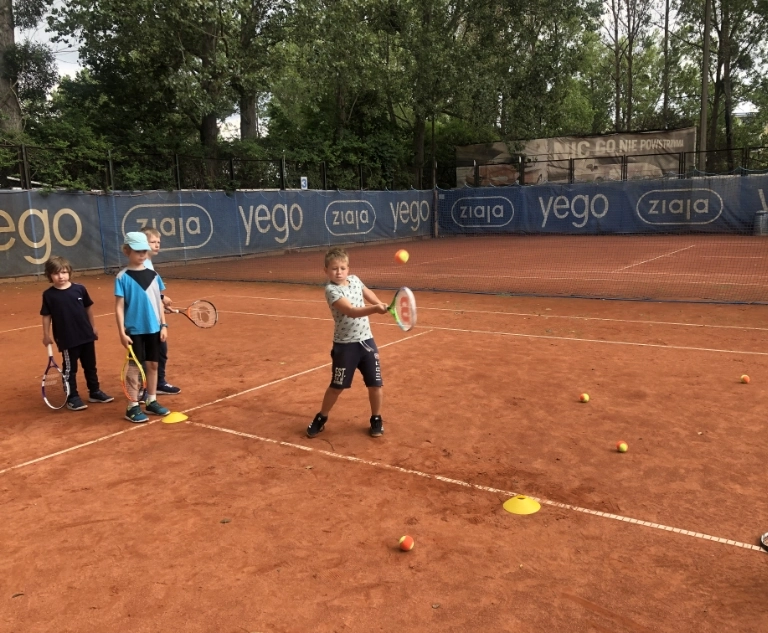Dzieci uczące się gry w tenisa 